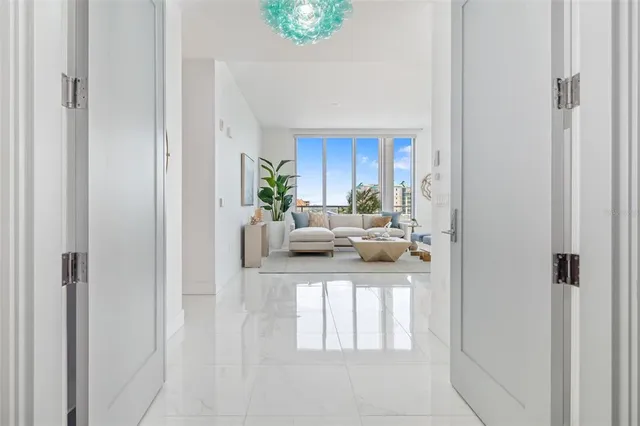 a living room with furniture and kitchen view