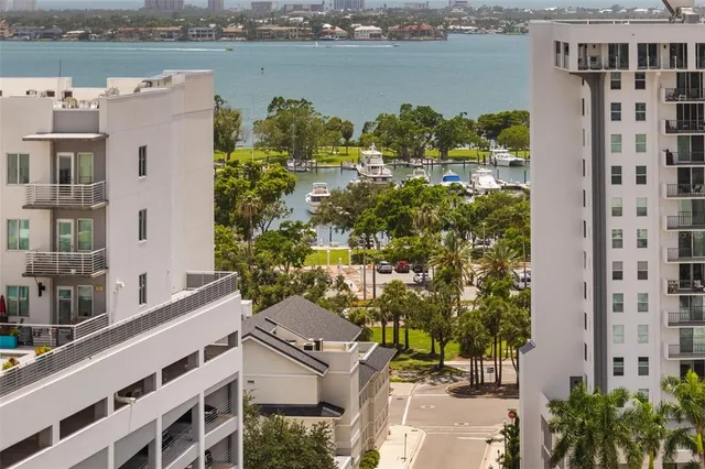 a living room with stainless steel appliances furniture a refrigerator and a view of kitchen