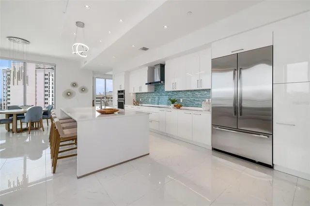 a kitchen with granite countertop white cabinets and stainless steel appliances