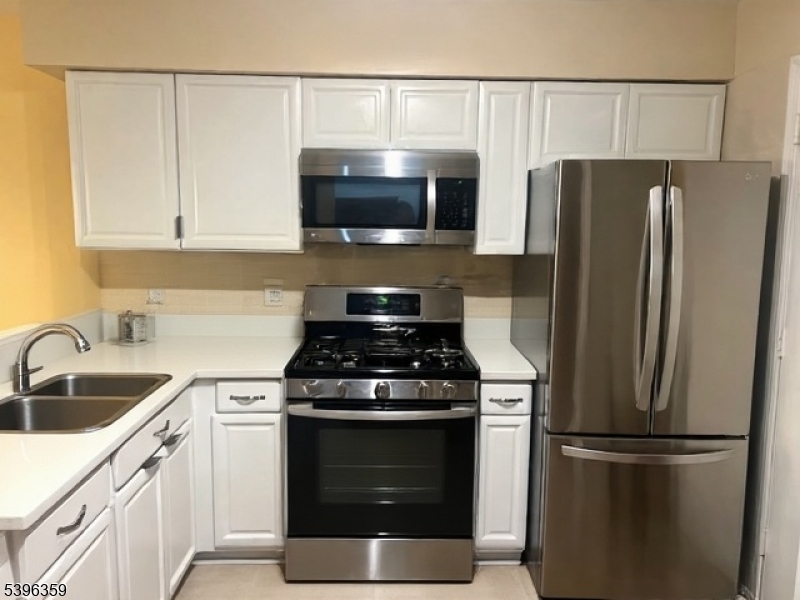 199 Hyde Park Road Somerset, NJ 08873 - Photo 6 of 17 a kitchen with cabinets stainless steel appliances and wooden floor
