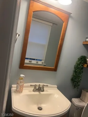 a bathroom with a toilet sink and mirror