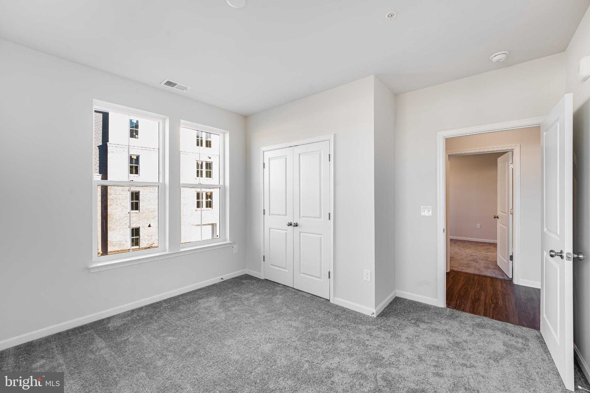 4003 Seaside Alder Road, Unit 203 Bowie, MD 20720 - Photo 15 of 22 an empty room with windows and closet