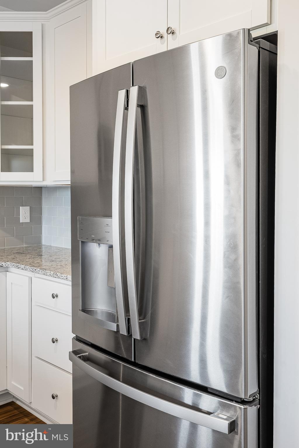 4003 Seaside Alder Road, Unit 203 Bowie, MD 20720 - Photo 6 of 22 a view of a refrigerator and cabinets