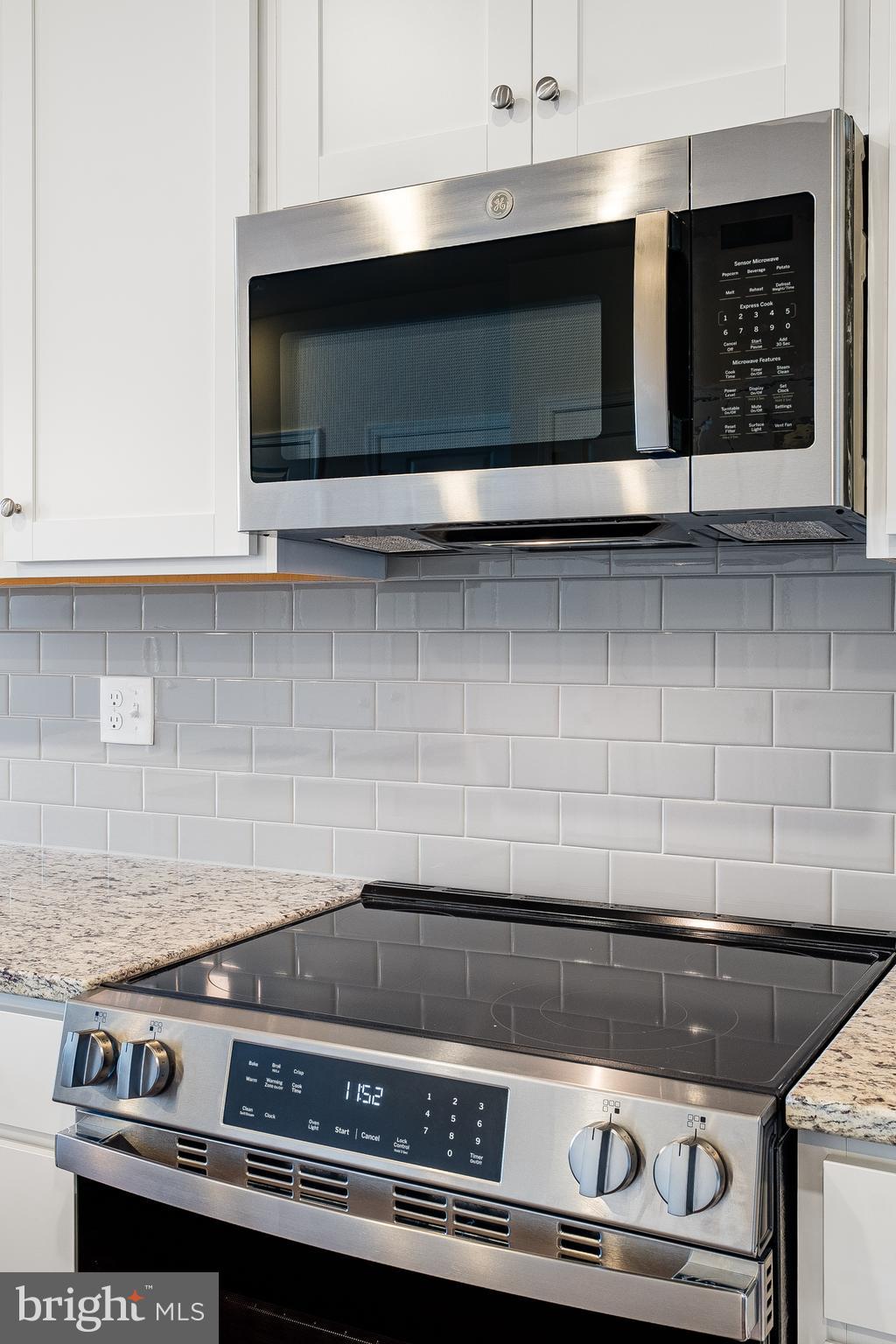4003 Seaside Alder Road, Unit 203 Bowie, MD 20720 - Photo 7 of 22 a stove top oven sitting inside of a kitchen