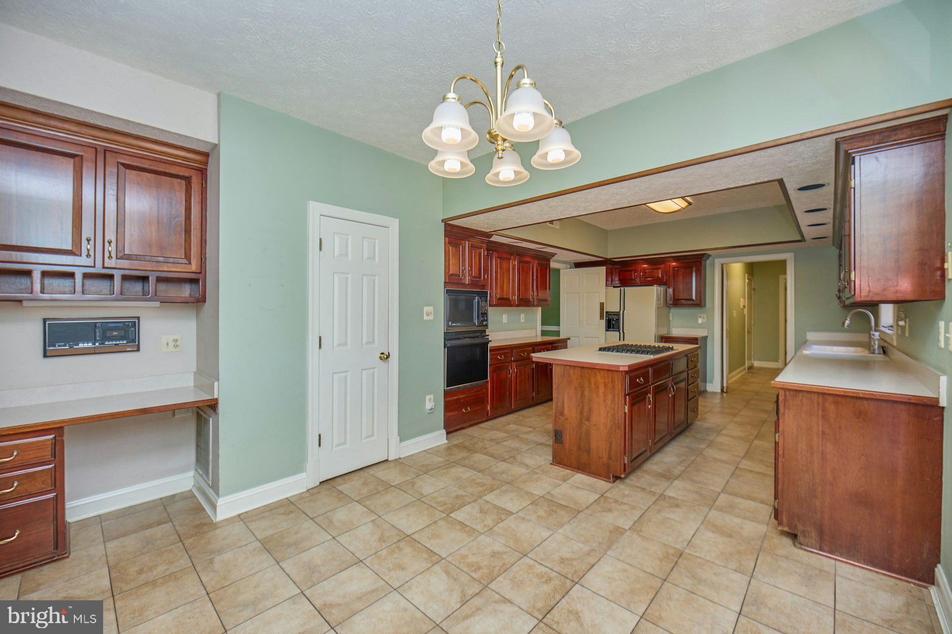 6051 Adams Drive La Plata, MD 20646 - Photo 18 of 72 a kitchen island with cabinets and stainless steel appliances