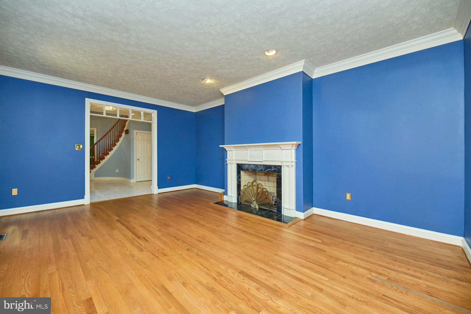 6051 Adams Drive La Plata, MD 20646 - Photo 23 of 72 a view of empty room with wooden floor and a fireplace