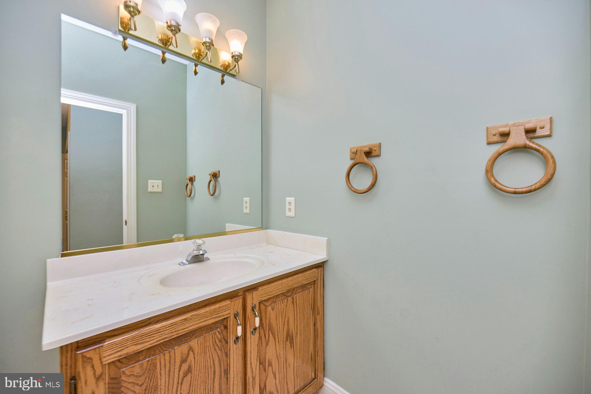 6051 Adams Drive La Plata, MD 20646 - Photo 29 of 72 a bathroom with a granite countertop sink and a mirror