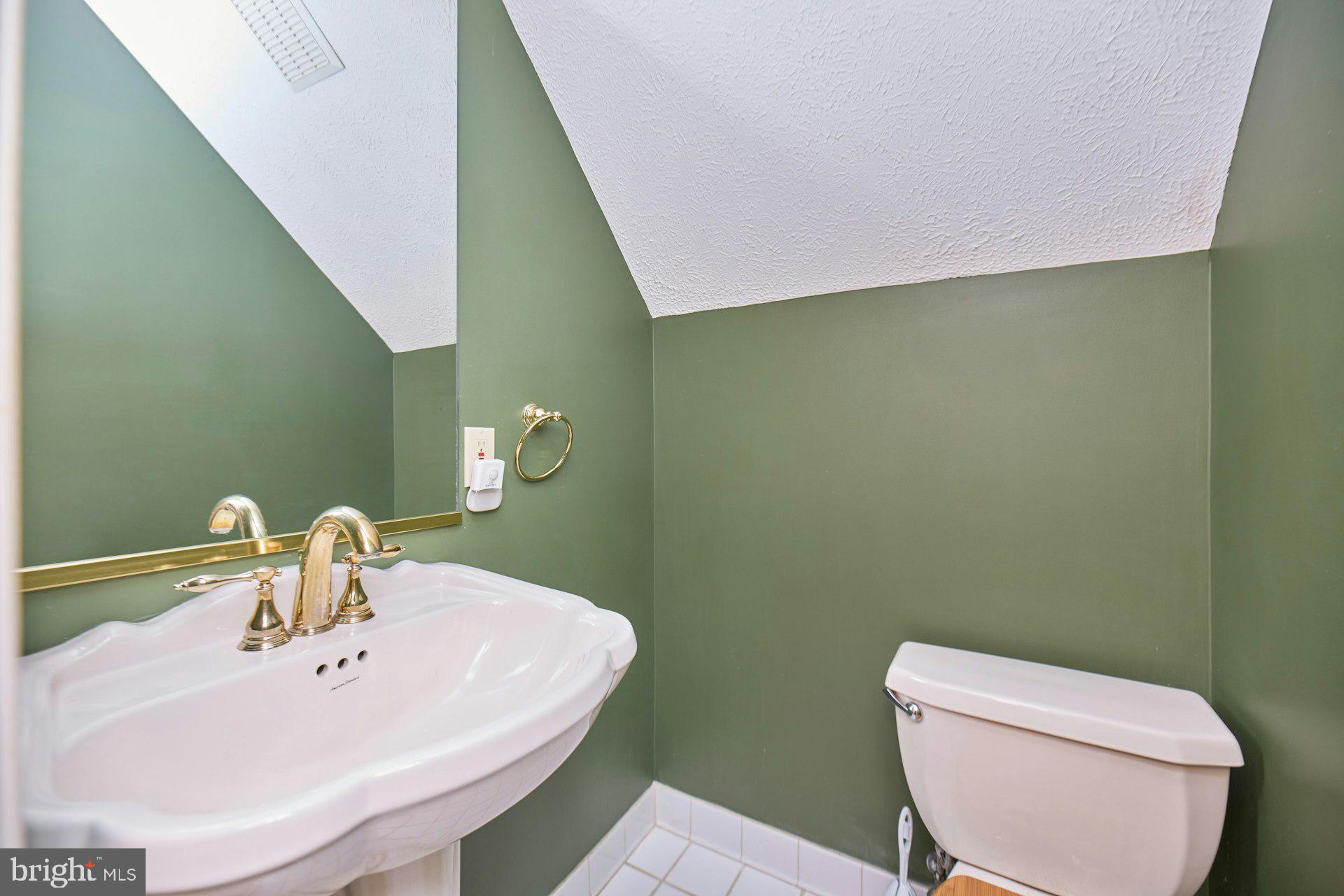 6051 Adams Drive La Plata, MD 20646 - Photo 30 of 72 a bathroom with a toilet a sink and mirror