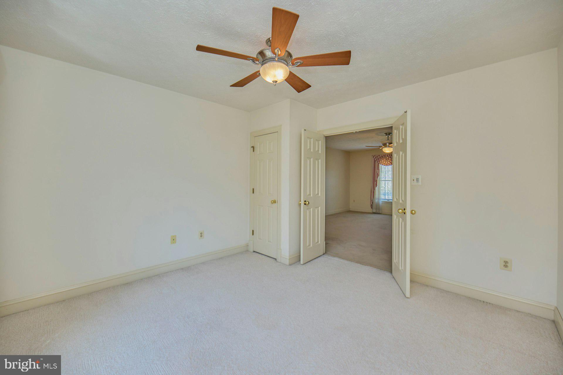 6051 Adams Drive La Plata, MD 20646 - Photo 37 of 72 an empty room with a ceiling fan and a window