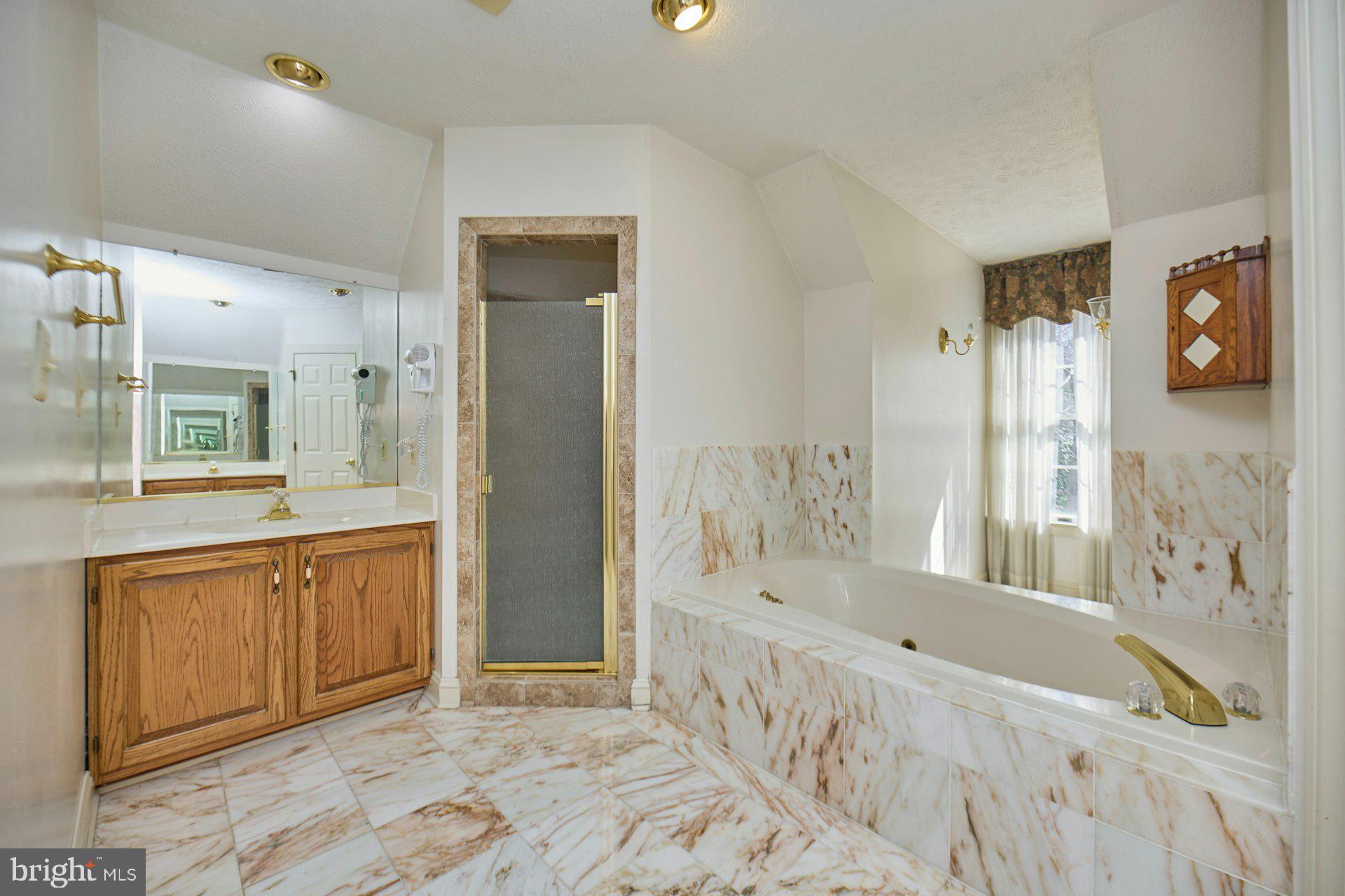 6051 Adams Drive La Plata, MD 20646 - Photo 38 of 72 a bathroom with a tub sink and mirror