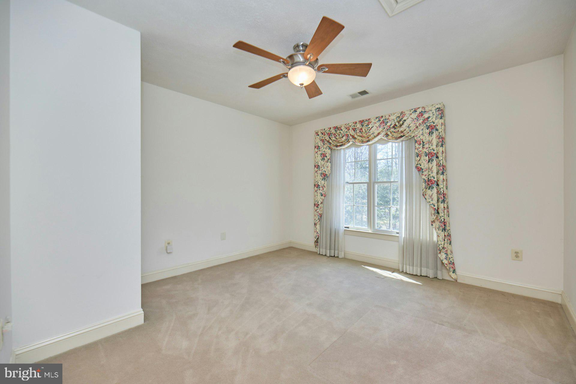 6051 Adams Drive La Plata, MD 20646 - Photo 41 of 72 an empty room with a ceiling fan and window