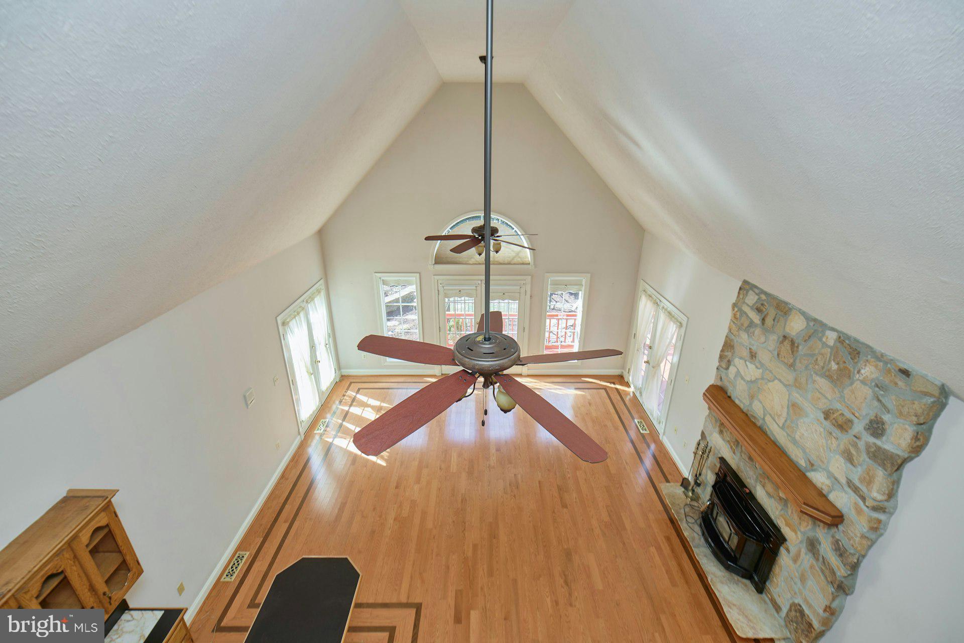 6051 Adams Drive La Plata, MD 20646 - Photo 49 of 72 a view of a livingroom with wooden floor and a ceiling fan