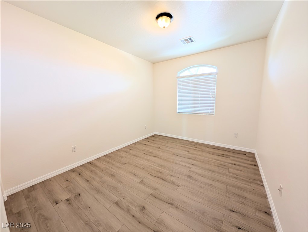 7011 Amapa Road Las Vegas, NV 89178 - Photo 19 of 32 Empty room featuring wood finished floors and baseboards
