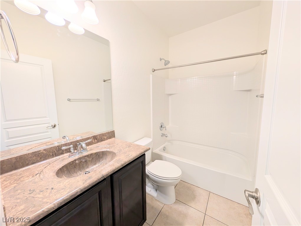 7011 Amapa Road Las Vegas, NV 89178 - Photo 20 of 32 Bathroom featuring shower / bath combination, vanity, and light tile patterned floors