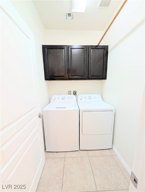 7011 Amapa Road Las Vegas, NV 89178 - Photo 25 of 32 Laundry area with cabinet space, light tile patterned floors, and washing machine and dryer