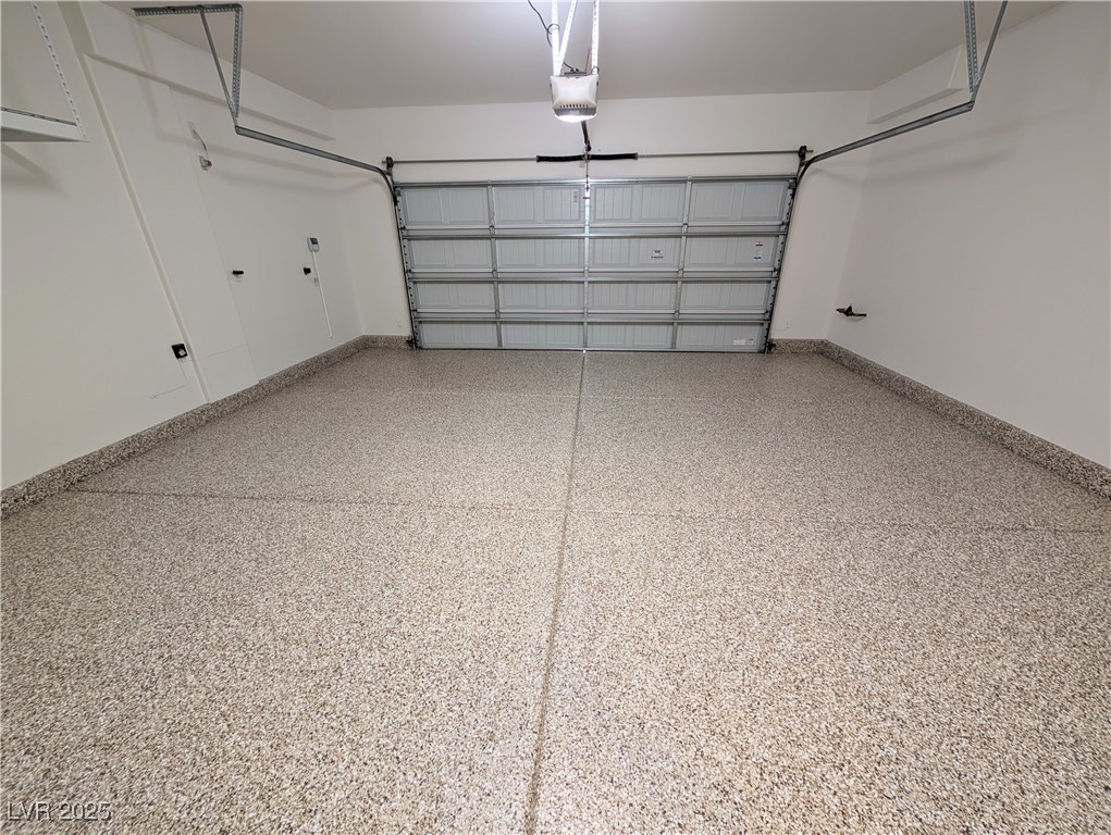 7011 Amapa Road Las Vegas, NV 89178 - Photo 26 of 32 Garage featuring baseboards and a garage door opener