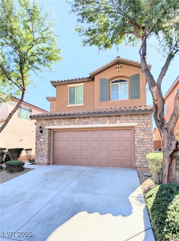 7011 Amapa Road Las Vegas, NV 89178 - Photo 3 of 32 Mediterranean / spanish house with stone siding, an attached garage, stucco siding, driveway, and a tile roof