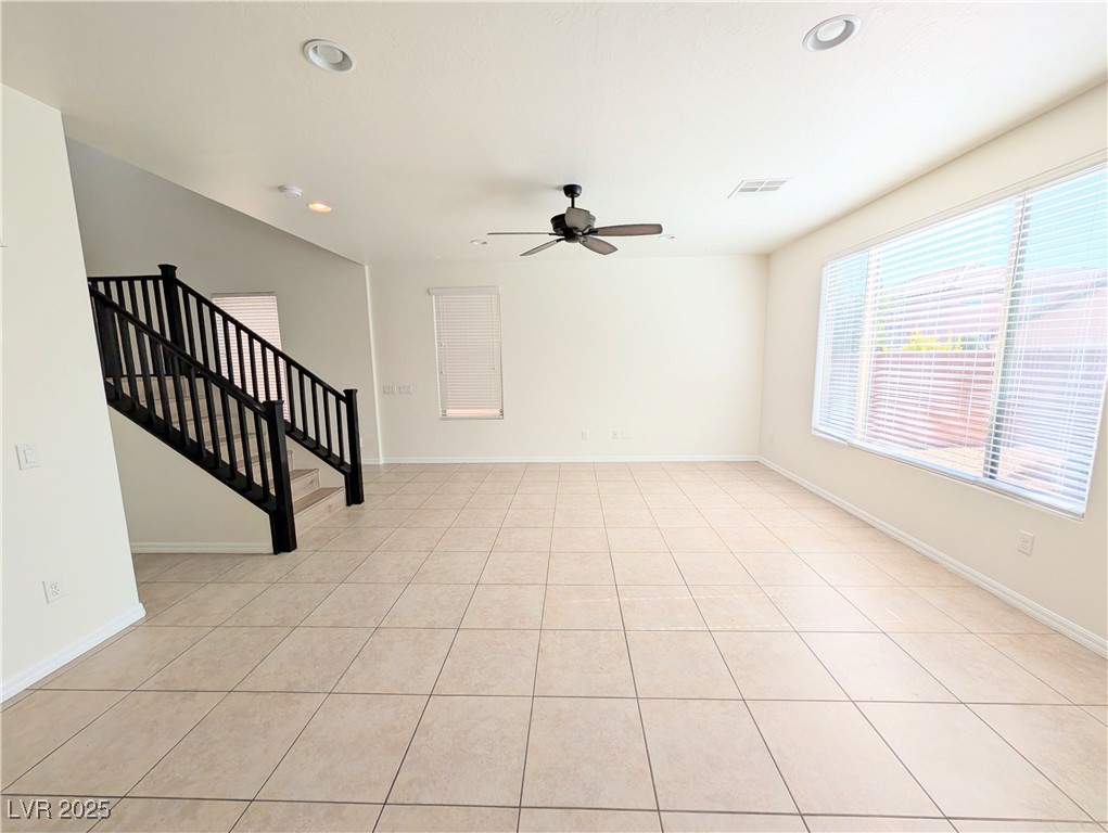 7011 Amapa Road Las Vegas, NV 89178 - Photo 9 of 32 Spare room with recessed lighting, stairs, light tile patterned flooring, and ceiling fan