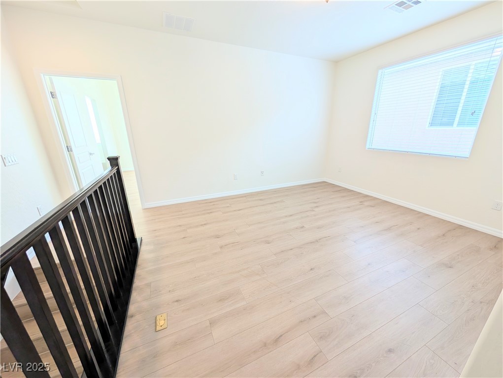 7011 Amapa Road Las Vegas, NV 89178 - Photo 10 of 32 Empty room featuring light wood-type flooring