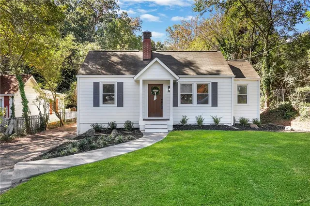 a front view of a house with a garden