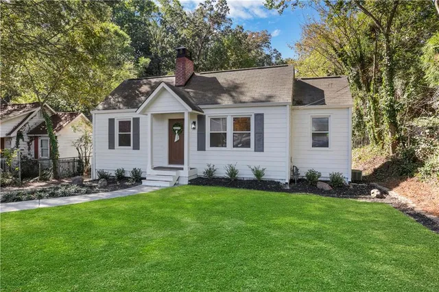 a living room with furniture a fireplace and a window