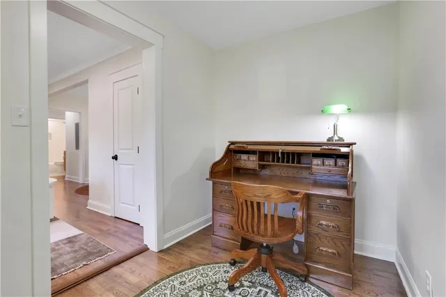 a bathroom with a toilet a sink a large mirror and vanity
