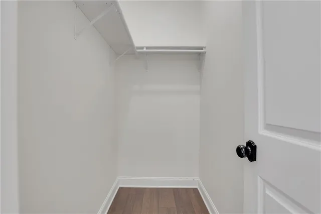 a view of a hallway with wooden floor and entryway