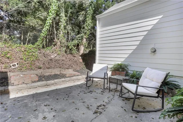 a view of a chairs and table in the back yard