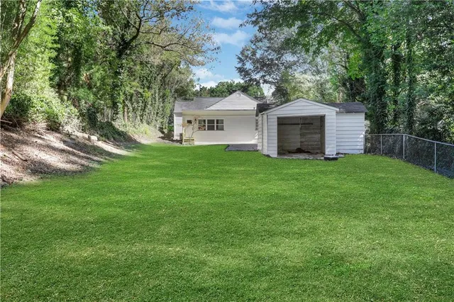 a front view of a house with yard and green space