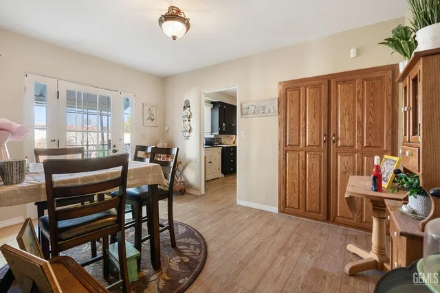 a bedroom with a bed a couch and chandelier