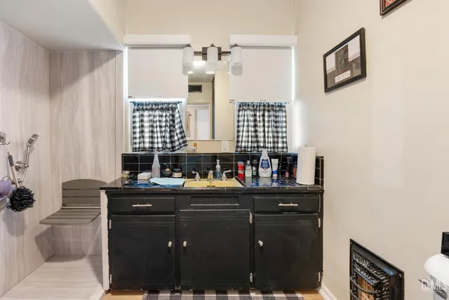 a living room with furniture and a ceiling fan