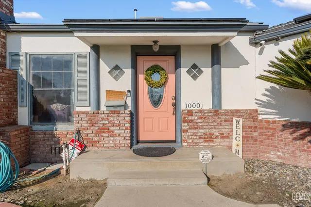 a living room with furniture a fireplace and a potted plant