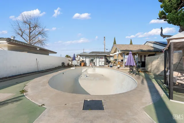 a kitchen with stainless steel appliances kitchen island granite countertop a sink a counter space and a window