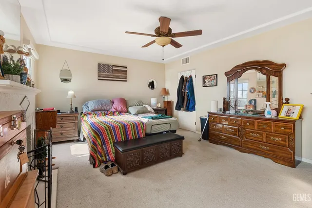 a view of a hallway with wooden floor and a bathroom