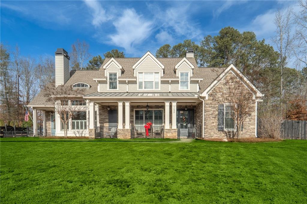 a view of a white house with a big yard and large trees