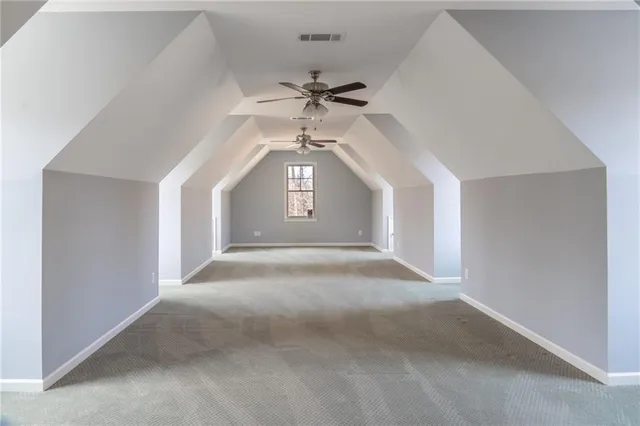 a view of a livingroom with a ceiling fan and window