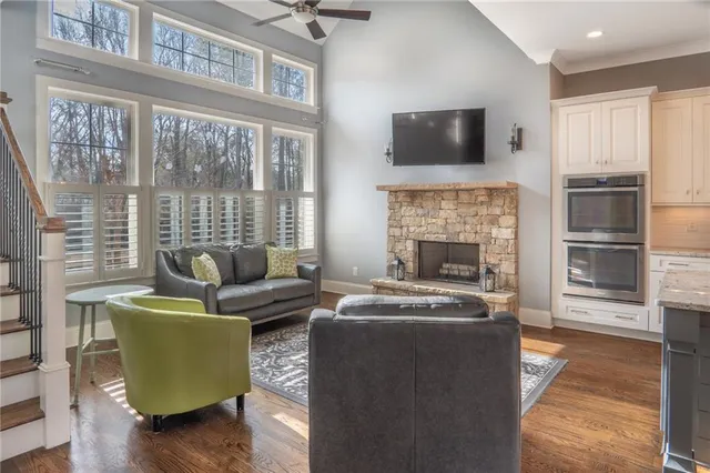 a living room with furniture a flat screen tv and a fireplace