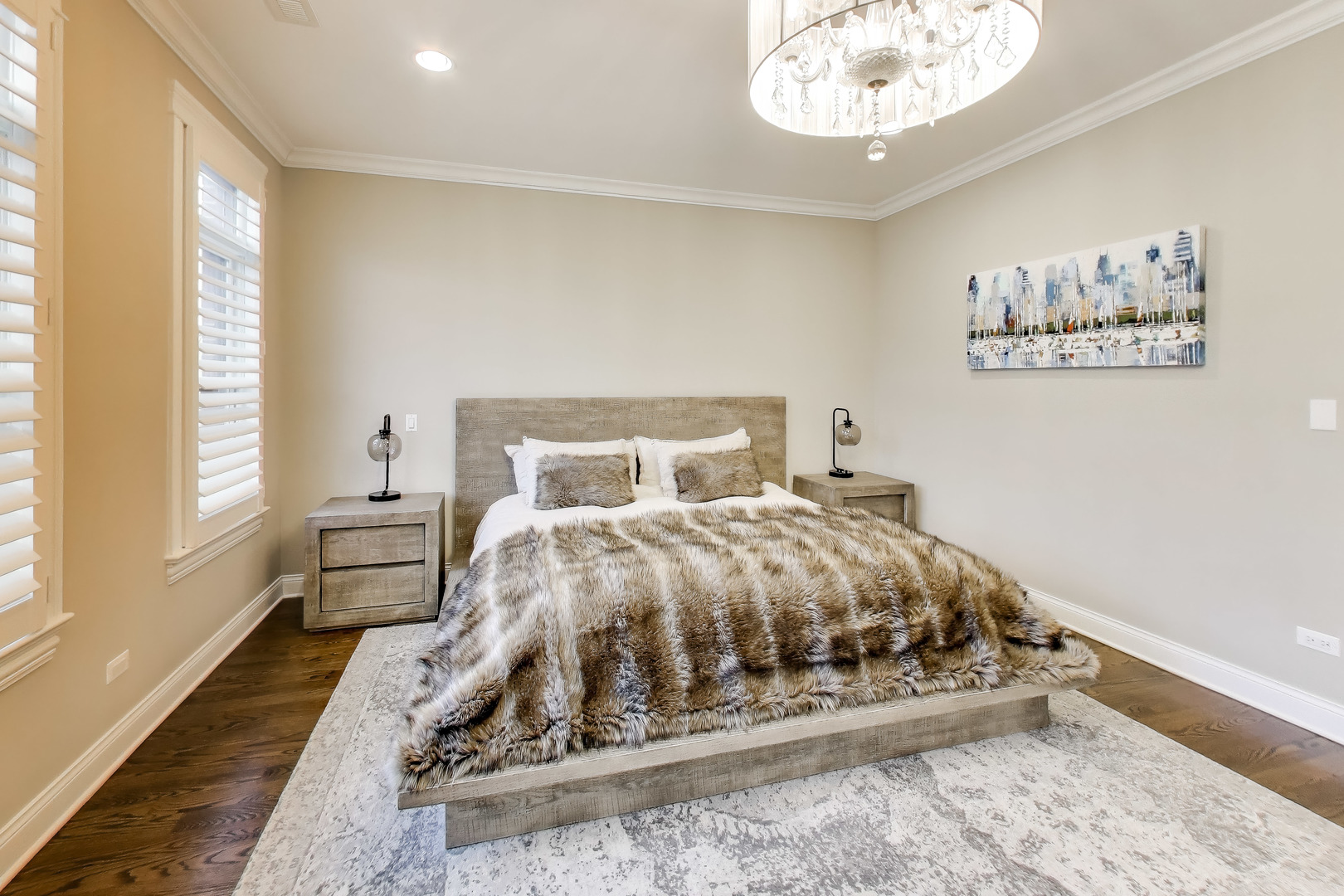 1226 West Henderson Street Chicago, IL 60657 - Photo 12 of 32 a bed sitting in a bedroom next to a window with a chandelier