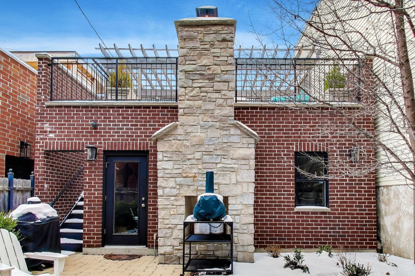 1226 West Henderson Street Chicago, IL 60657 - Photo 24 of 32 a front view of a house with glass door
