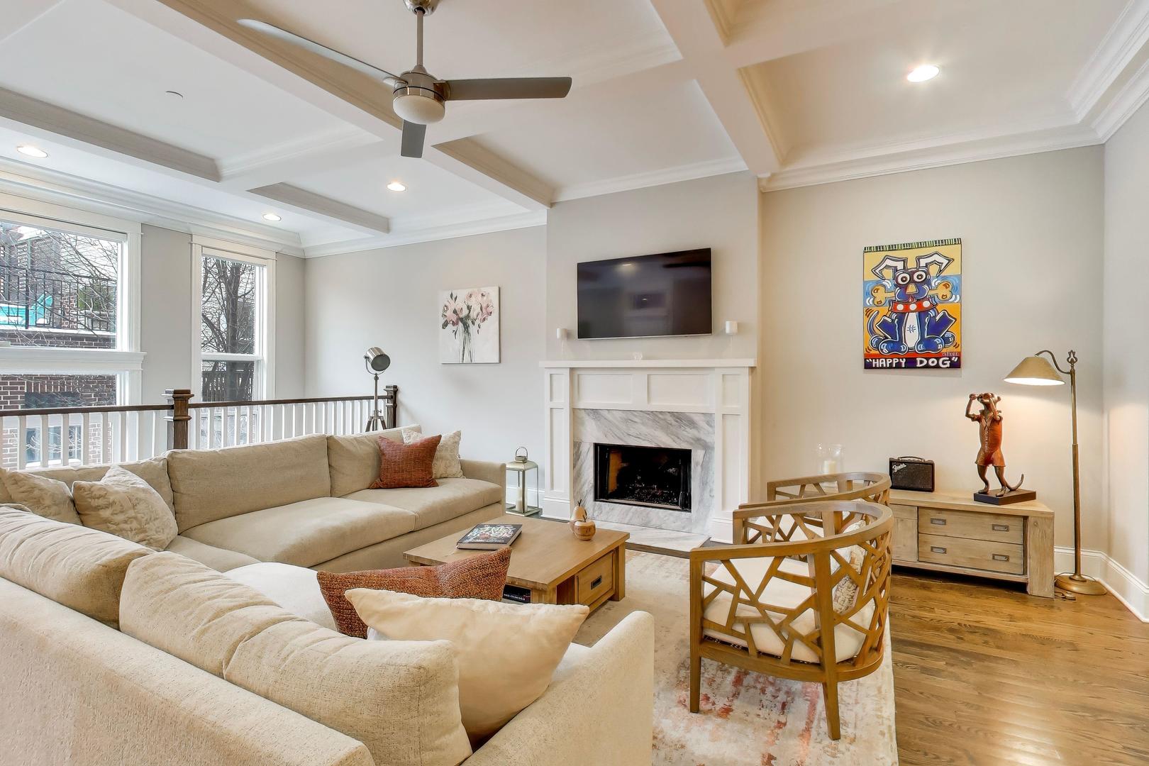 1226 West Henderson Street Chicago, IL 60657 - Photo 9 of 32 a living room with furniture a flat screen tv and a fireplace