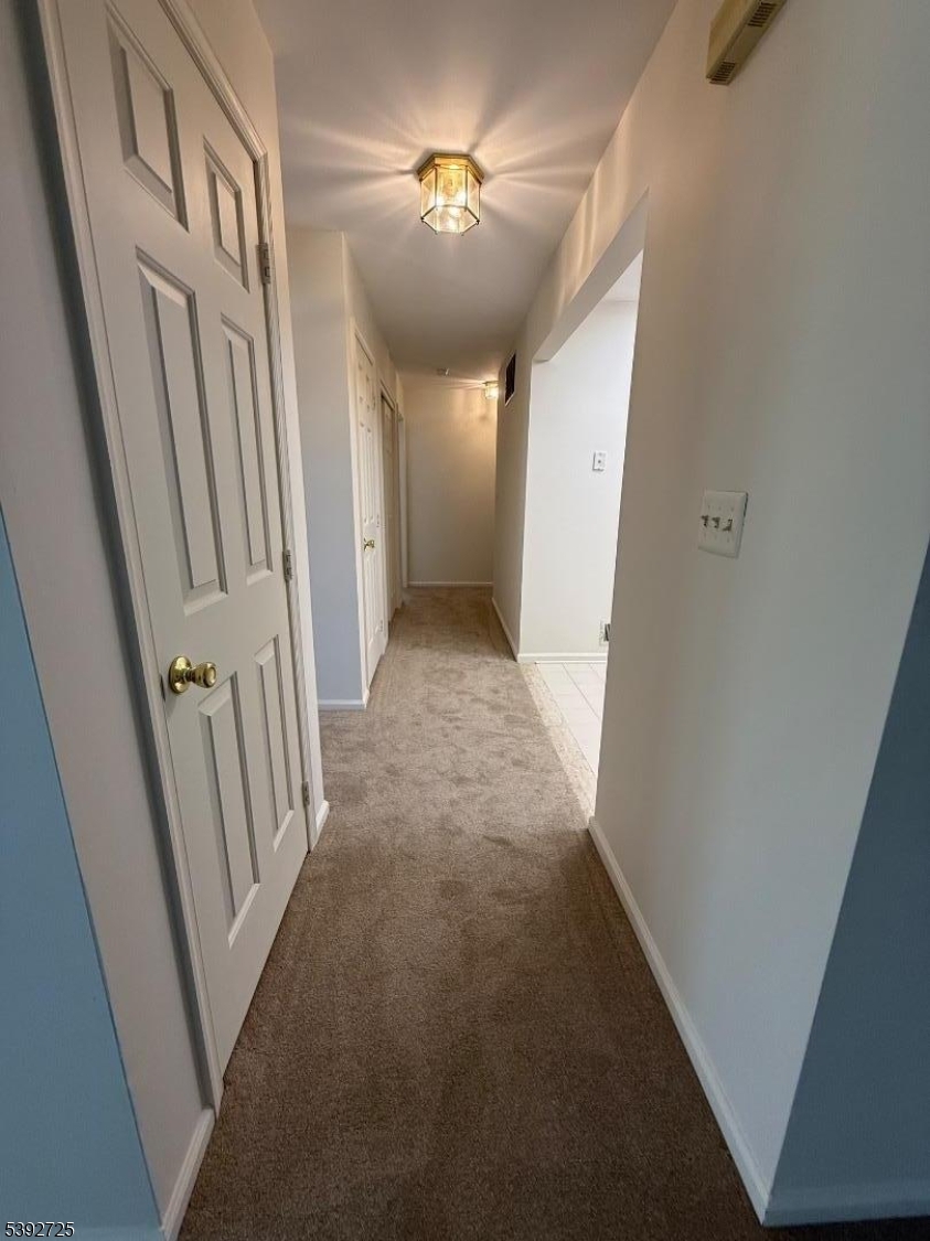 5111 Austin Court, Unit 11 Hackettstown, NJ 07840 - Photo 6 of 19 a view of a hallway view with staircase