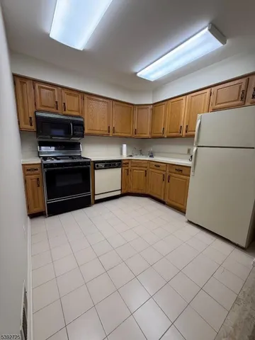 a kitchen with stainless steel appliances a stove a sink and a refrigerator