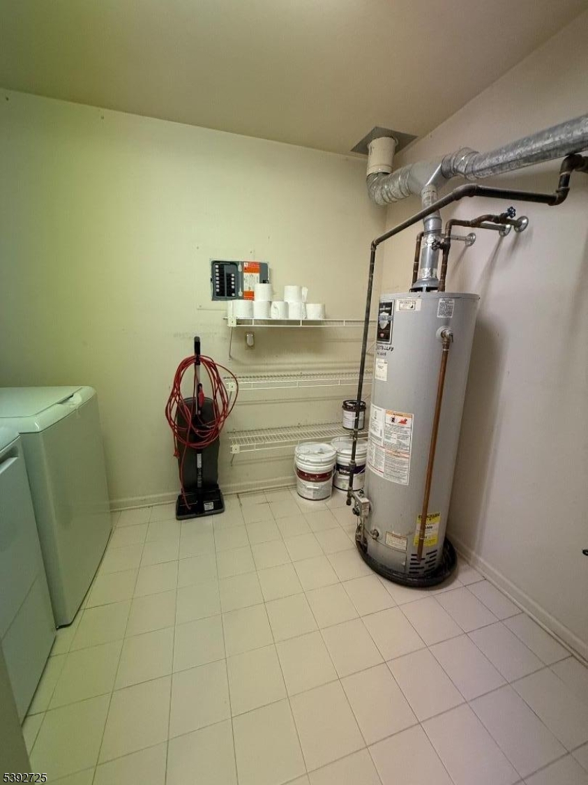 5111 Austin Court, Unit 11 Hackettstown, NJ 07840 - Photo 10 of 19 a view of a storage & utility room with water heater and racks