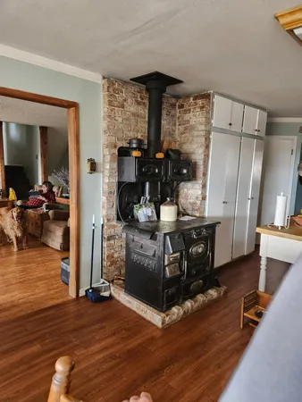 a view of living room kitchen with furniture and wooden floor