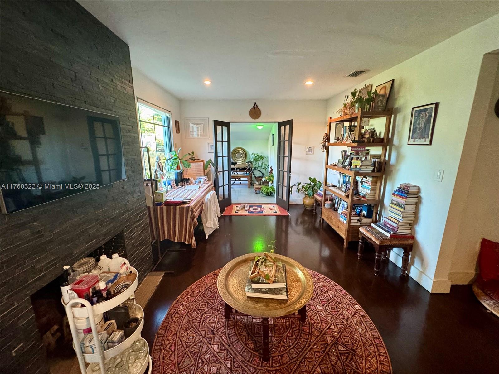 7020 Northeast 5th Avenue Miami, FL 33138 - Photo 12 of 42 a living room with furniture and a wooden floor