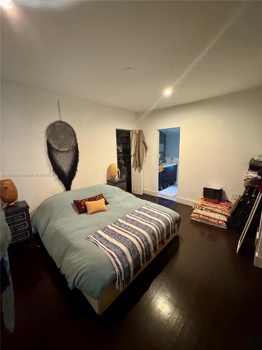 7020 Northeast 5th Avenue Miami, FL 33138 - Photo 13 of 42 a bedroom with a bed and a large mirror