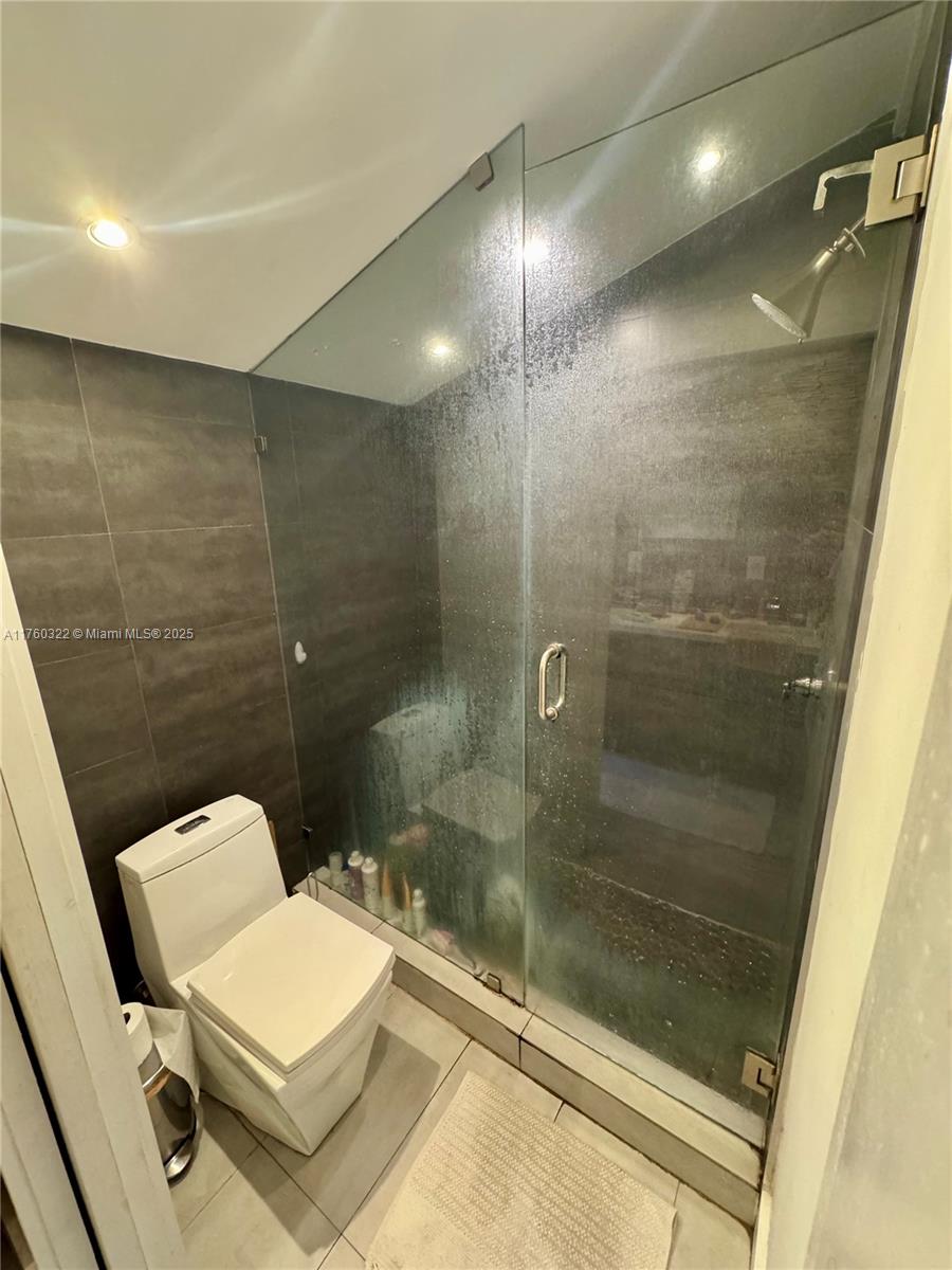 7020 Northeast 5th Avenue Miami, FL 33138 - Photo 15 of 42 a bathroom with a bathtub and a toilet