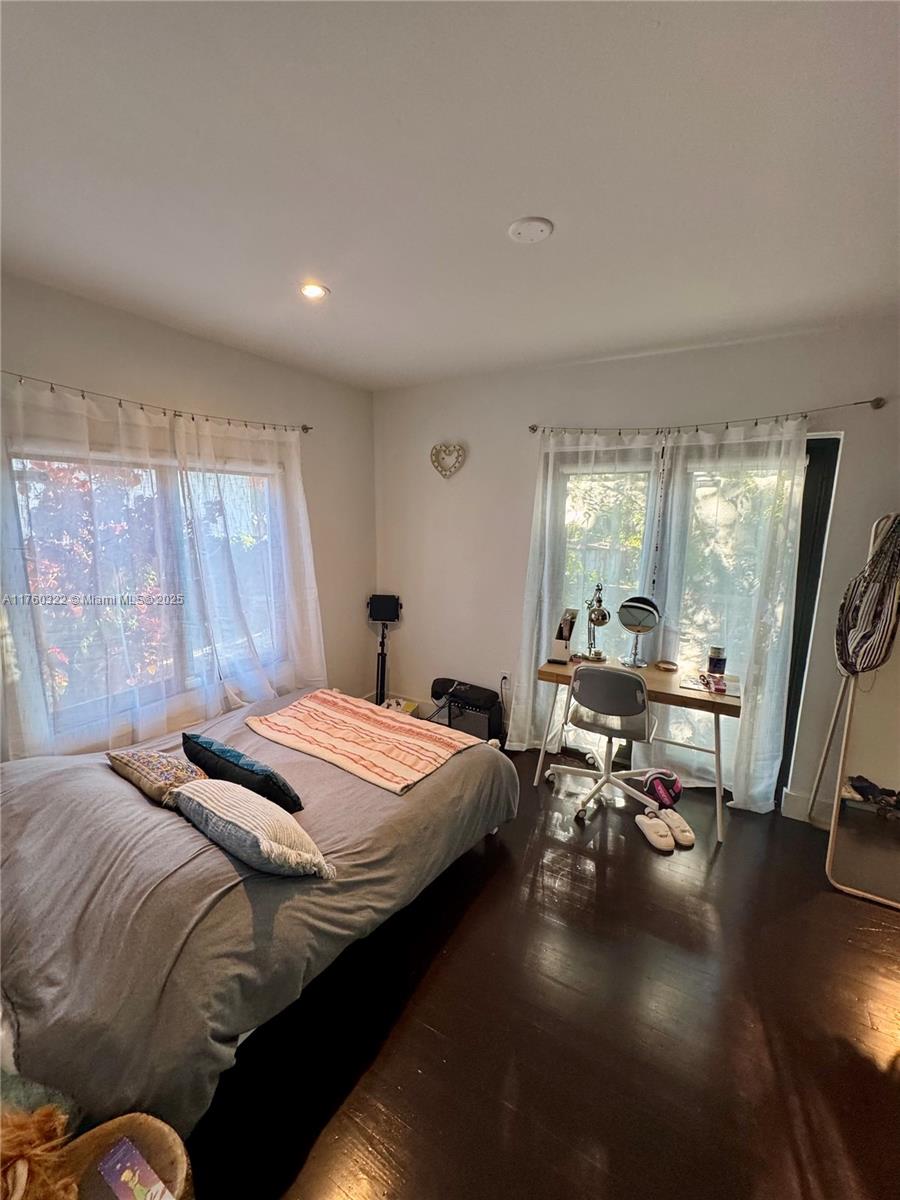 7020 Northeast 5th Avenue Miami, FL 33138 - Photo 17 of 42 a bedroom with a bed and wooden floor