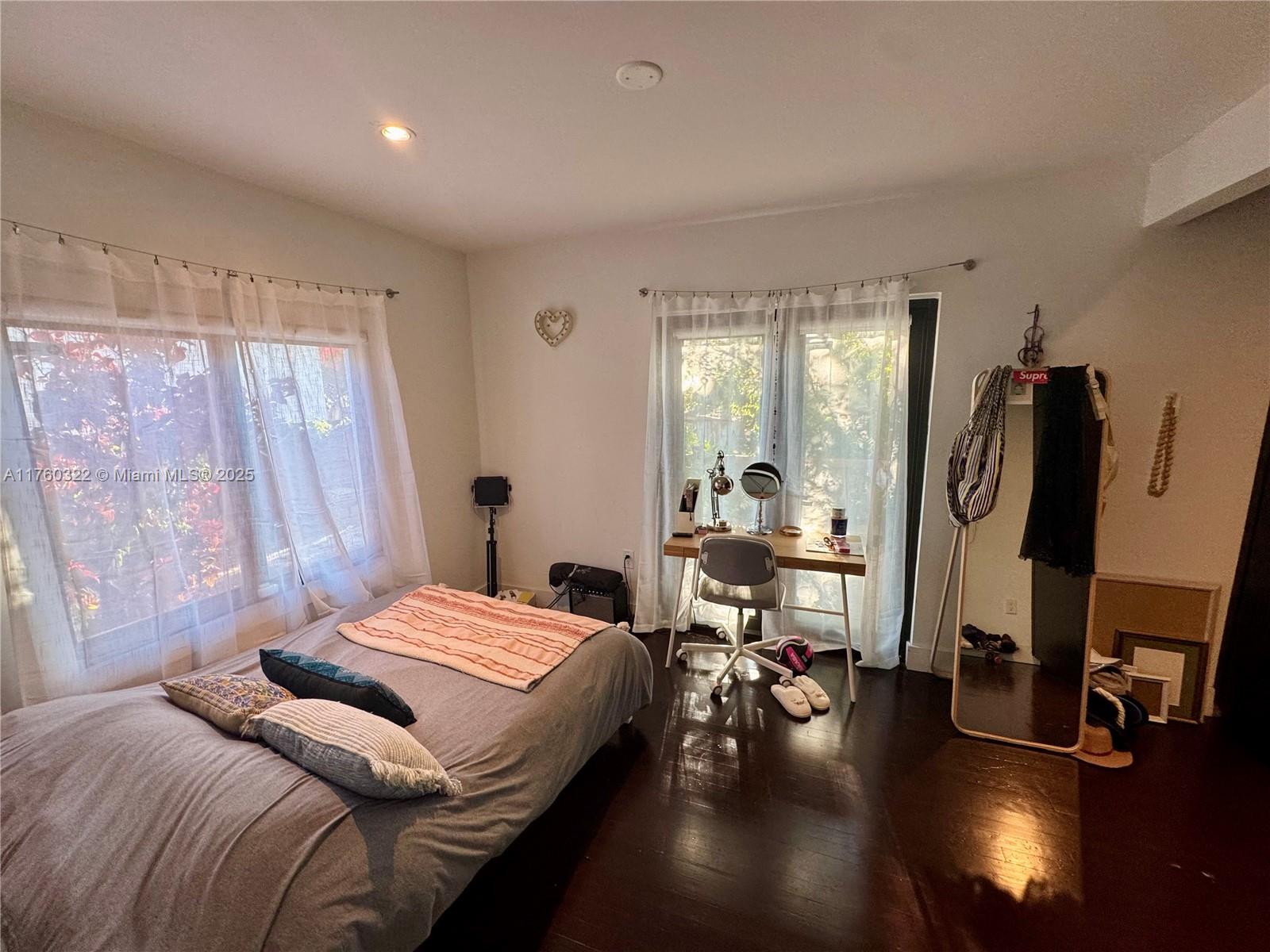 7020 Northeast 5th Avenue Miami, FL 33138 - Photo 18 of 42 a bedroom with a bed gym equipment and a large window