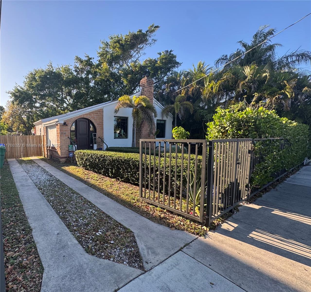 7020 Northeast 5th Avenue Miami, FL 33138 - Photo 25 of 42 a front view of house with yard and trees in the background